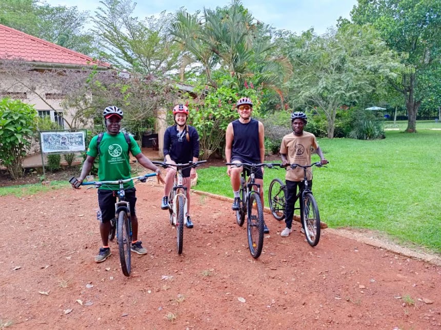 Guide and guests with bicycles, ready for a ride in Kampala